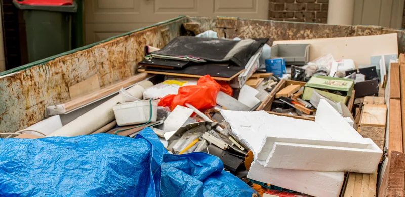 Junk removal crew hauling heavy items from garage cleanout in Florida